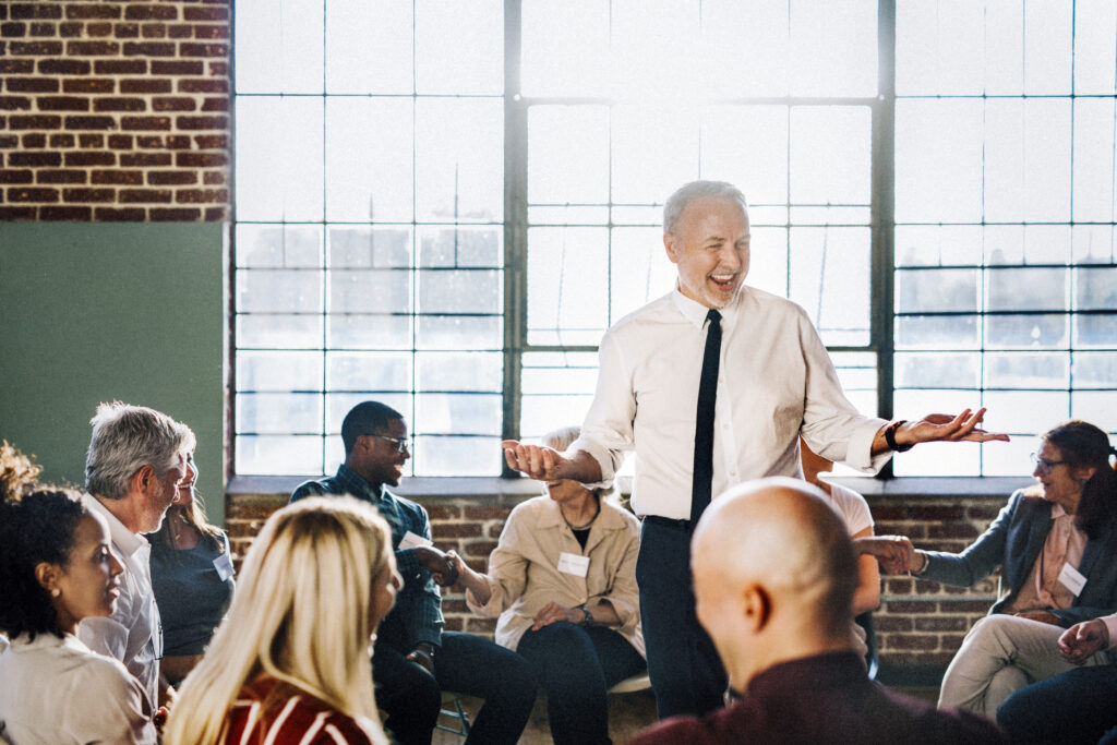 A leadership and management trainer talking in a seminar